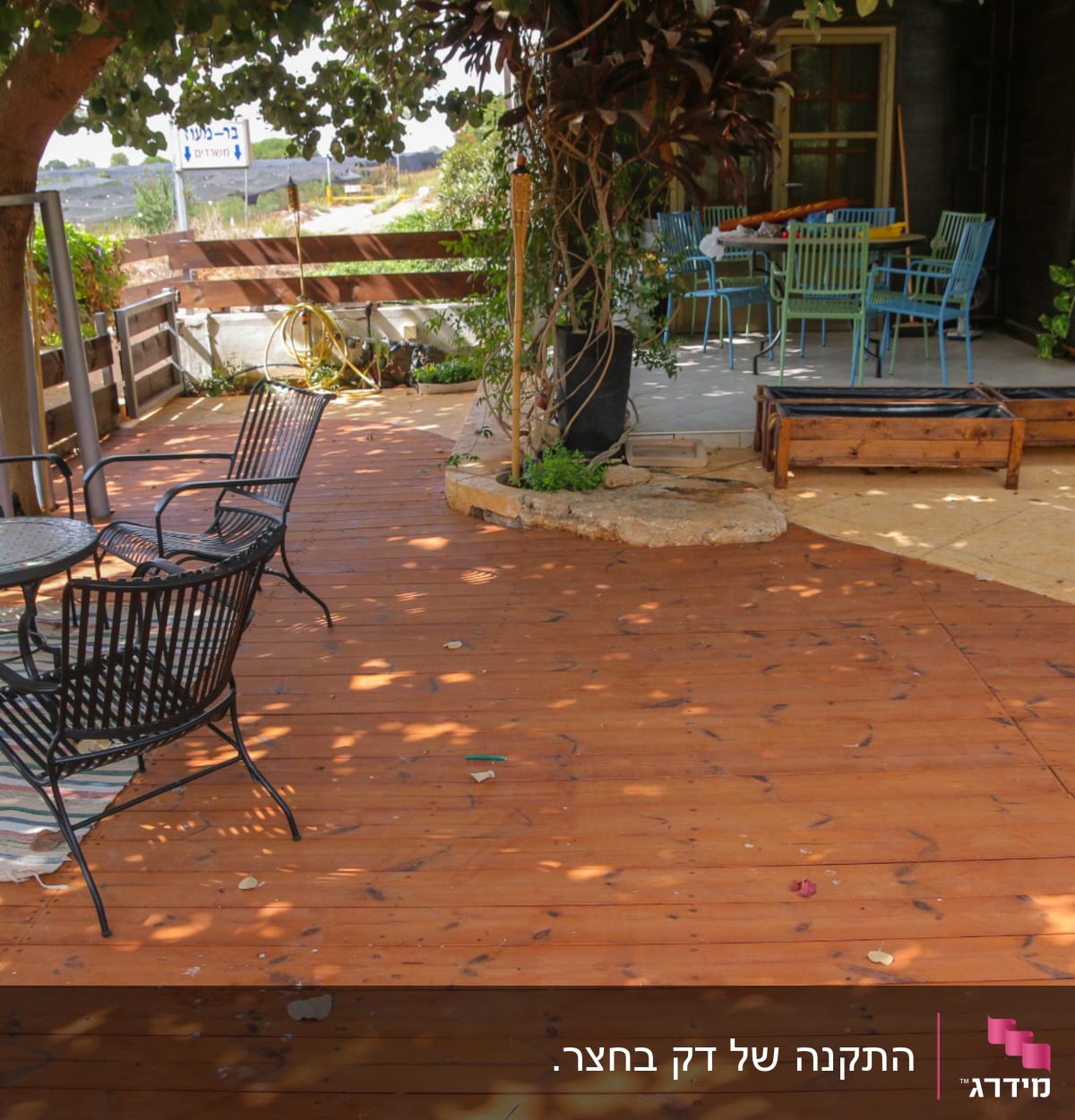 רצפת עץ עם שולחנות וכיסאות בגינה